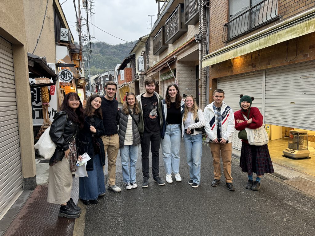 A group of the nine students involved in the Digital Sojourns Project on a Kyoto Street in March 2024